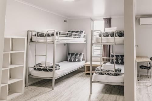a room with three bunk beds in it at Yamba Central in Yamba