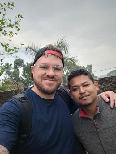 two men are standing next to each other at Hotel National Park- A peaceful Family home where you can stay Peace and Enjoy and Organize the wildlife Safari in Chitwan