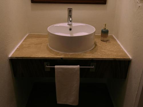 a sink in a bathroom with a towel on a counter at HOTEL ISLA in Isla Aguada
