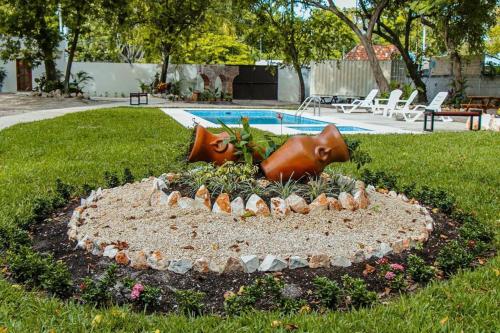 a garden with a bird bath in the grass at HOTEL ISLA in Isla Aguada