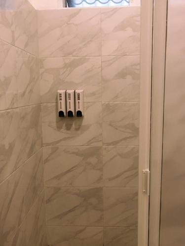 a bathroom with a shower with two outlets on the wall at HOTEL ISLA in Isla Aguada