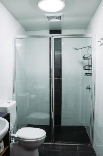 a bathroom with a shower and a toilet at Yamba Central in Yamba