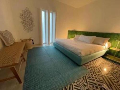 a bedroom with a bed with a green headboard at Luxury 1 Bedroom Beach House Casa Dos Aguas in Yelapa