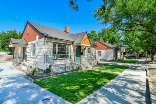 a large white house with a yard at North End Bungalows Downstairs in Boise