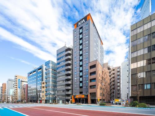 a tall building with a nazi sign on top of it at APA Hotel Asakusa Kuramae Kita in Tokyo