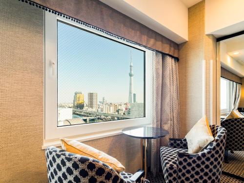 a room with a window with a view of a city at APA Hotel Asakusa Kuramae Kita in Tokyo