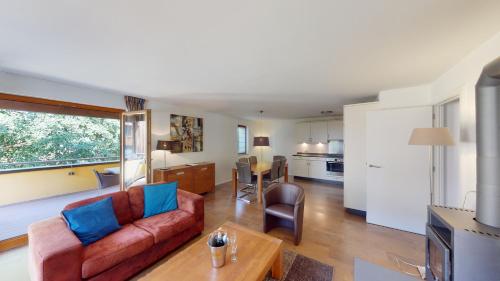a living room with a couch and a table at Walensee House & Apartments in Unterterzen