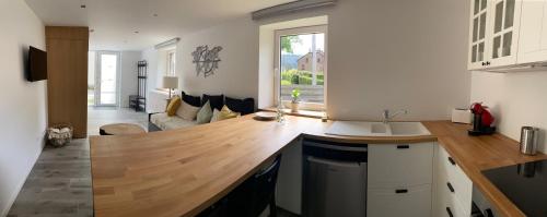 a kitchen with a wooden counter top in a room at Cocoon in Stavelot