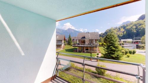 a balcony with a view of a house at Walensee House & Apartments in Unterterzen