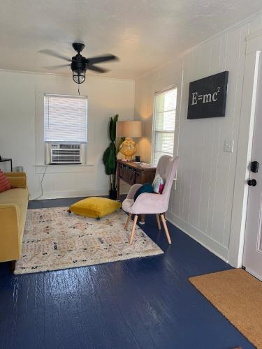 a living room with a couch and a chair and a desk at The Haven in Brookhaven