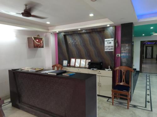 a bar in a room with a table and chairs at Hotel Geetanjali Palace in Kalyani