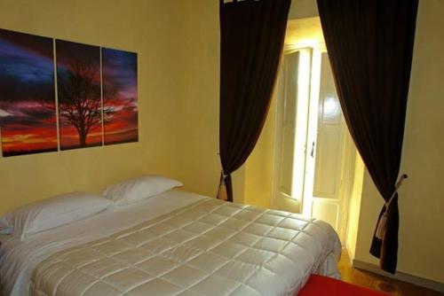 a bedroom with a white bed and a window at La Loggia Di Federico in Navelli