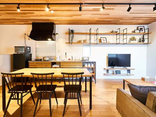 a kitchen and living room with a table and chairs at Rakuten STAY HOUSE x WILL STYLE Saga Imari 101 in Imari