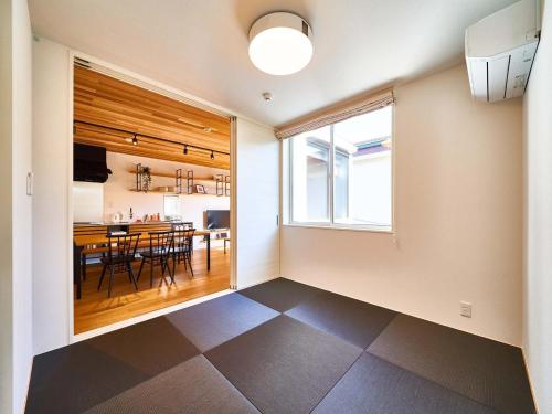 a kitchen and dining room with a table and a window at Rakuten STAY HOUSE x WILL STYLE Saga Imari 102 in Imari