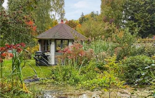 a small gazebo in the middle of a garden at 2 Bedroom Gorgeous Apartment In Undenäs in Undenäs