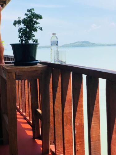 a potted plant sitting on a table on a balcony at Navareeya House Seaview in Ko Lanta