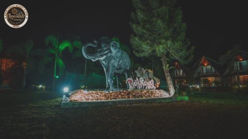 a statue of an elephant in a park at night at Chocolate Inn Rainforest Resort & Spa in Jalpāiguri