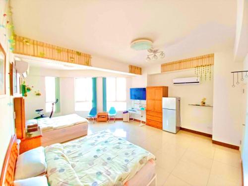 una grande camera con due letti e un frigorifero di Lohas-artist B&B a Chaozhou