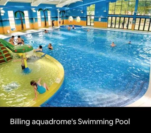a group of people swimming in a swimming pool at Billing Aquadrome, Kingfisher Meadows 12 in Great Billing
