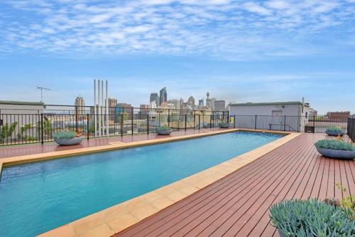 a large swimming pool on top of a building at Ultimate 2-Bed Apartment in Surry Hills - Ultimate Convenience in Sydney