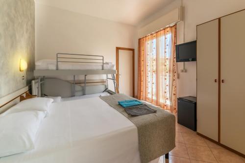 a bedroom with a bed and a bunk bed at Hotel Albatros in Rimini
