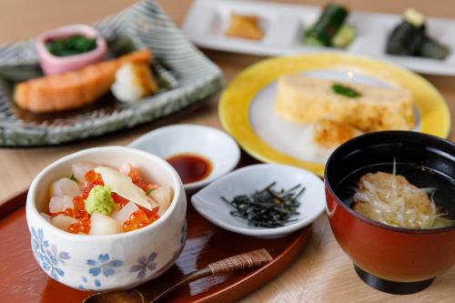 a table with bowls of food and plates of food at Matsushima Ichinobo in Matsushima