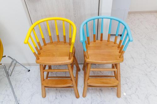 two wooden chairs sitting next to each other at Southerlies Condominium Onna in Onna