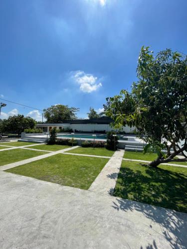 a view of a park with a building at Melinda’s Private Resort in Tarlac