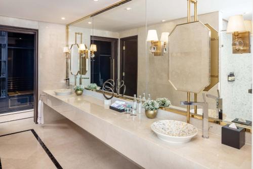 a bathroom with two sinks and a large mirror at Meliá Vinpearl Ha Tinh in Ha Tinh