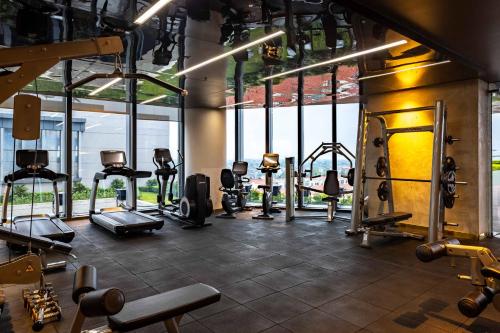 a gym with a bunch of treadmills and machines at Vinpearl Ha Tinh, Affiliated by Melia in Ha Tinh