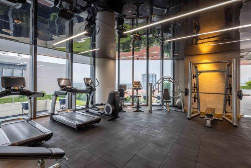 a gym with treadmills and cardio equipment in a building at Vinpearl Ha Tinh, Affiliated by Melia in Ha Tinh