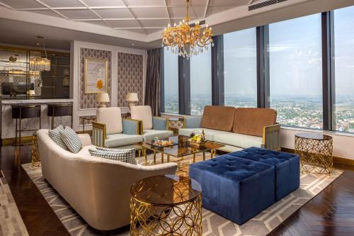 a living room filled with furniture and a chandelier at Vinpearl Ha Tinh, Affiliated by Melia in Ha Tinh
