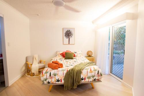 a bedroom with a bed and a window at Coolum Sands Beachside Apartment in Coolum Beach