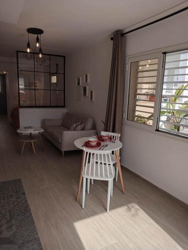 a living room with a table and a couch at Marsa BiBi in La Marsa
