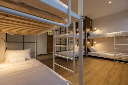 a room with two bunk beds in a building at Mini Voyage Hostel in Hualien City