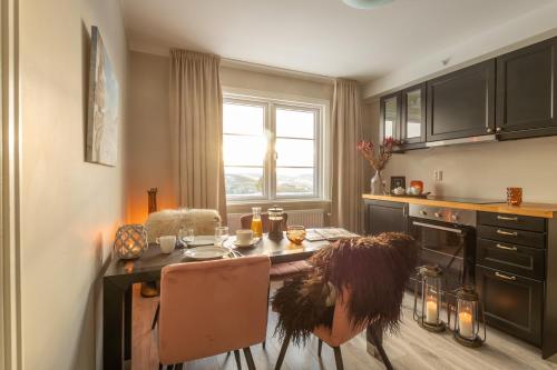 a person sitting at a table in a kitchen at Skåbu Fjellhotell in Skåbu