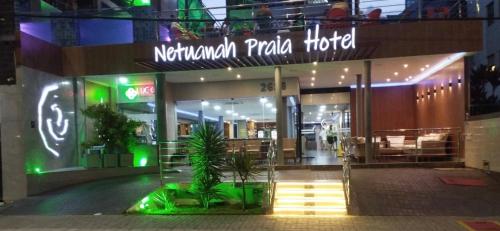 aventura plaza hotel at night with a sign on the building at Netuanah Praia Hotel in João Pessoa
