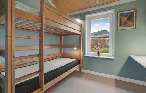 a bedroom with bunk beds and a window at 4 Bedroom Awesome Home In Egernsund in Egernsund