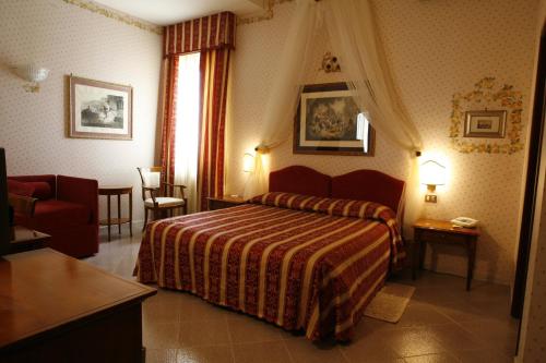 a hotel room with a bed and a chair at Miralago in Albano Laziale