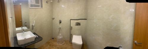 a bathroom with a toilet and a sink at JN Guestline in Devanahalli-Bangalore