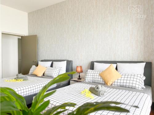 two beds sitting next to each other in a room at Seaview Suite SS Melaka by BetaStay in Melaka