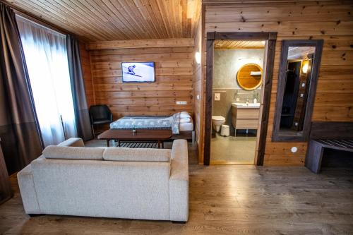 a living room with a couch and a bed and a bathroom at Lighthouse-Inn in Gardur