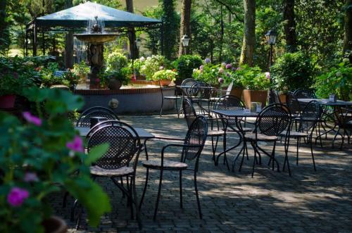 a group of tables and chairs in a garden at Miralago in Albano Laziale