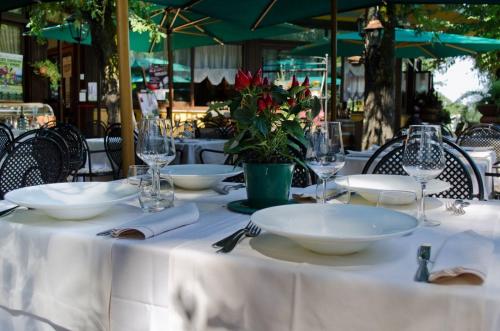 a table with white plates and glasses on it at Miralago in Albano Laziale