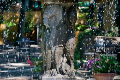a water fountain with a statue of a woman at Miralago in Albano Laziale