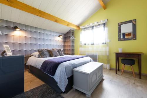 a bedroom with a large bed and a mirror at Le Cabanot in Peyrusse-Grande