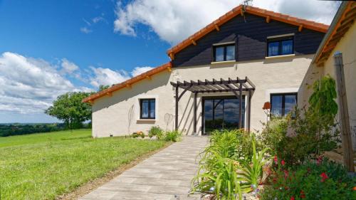 a large white house with a black roof at Le Cabanot in Peyrusse-Grande
