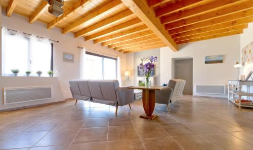 a large living room with a table and chairs at Le Cabanot in Peyrusse-Grande
