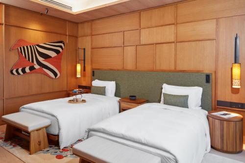 two beds in a room with wood paneling at The Ritz-Carlton, Istanbul at the Bosphorus in Istanbul