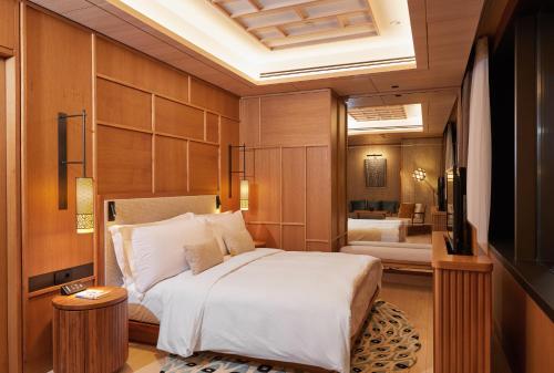 a bedroom with a large bed and a television at The Ritz-Carlton, Istanbul at the Bosphorus in Istanbul